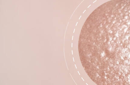 Close-up of smooth skin texture with soft focus, featuring a circular detail highlighting a slightly textured area.