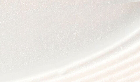 Close-up of a smooth, glossy surface with subtle shimmering and curved patterns.