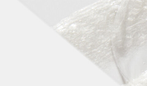 Close-up of a smooth, white substance with a soft, textured appearance, set against a light background.