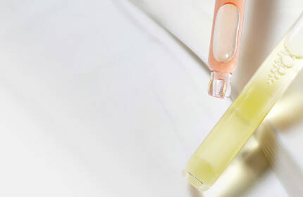 Three skincare products from SkinCeuticals are displayed: a jar of Triple Lipid Restore 2:4:2 cream and two serums in purple and brown glass bottles labeled H.A. Intensifier and C E Ferulic. The background is a light grey color.