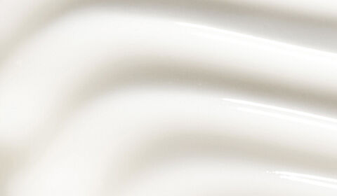 Two skincare products from SkinCeuticals are displayed against a soft, cream-colored background. The left product is a tube labeled "Retinol 0.5," and the right product is a dark glass bottle labeled "Hydrating B5."