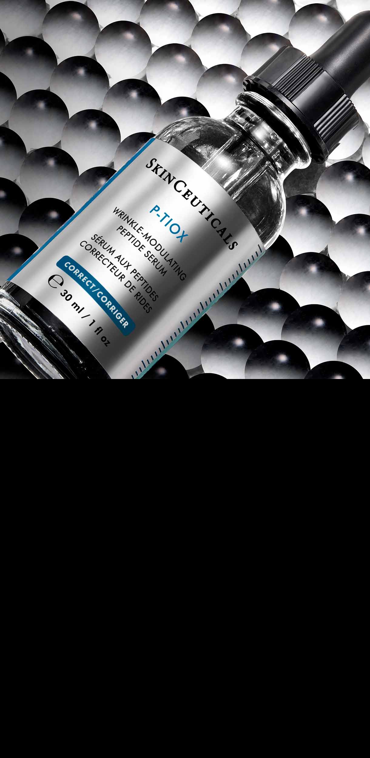 A SkinCeuticals P-Tiox Serum bottle lies at an angle on a background of densely packed, glossy black and grey spheres, creating a textured and scientific aesthetic.